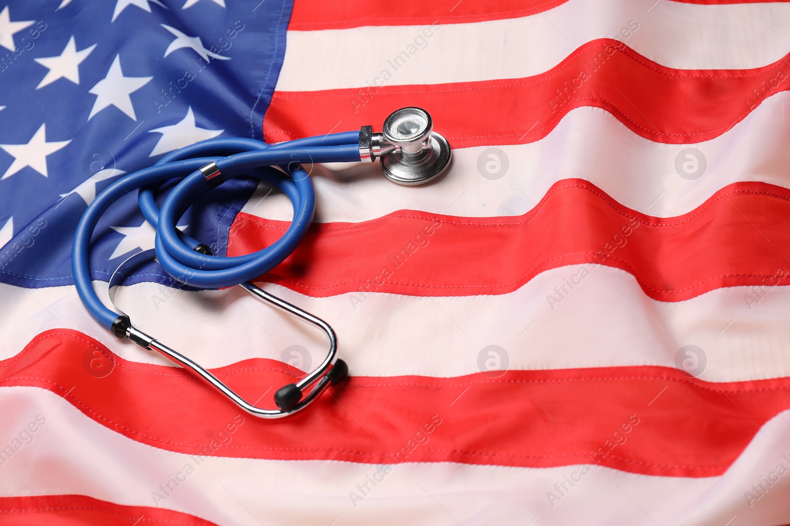 Photo of Stethoscope on USA flag, closeup. Health care concept