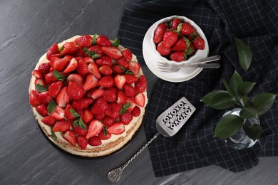 Tasty cake with fresh strawberries and mint served on table, flat lay