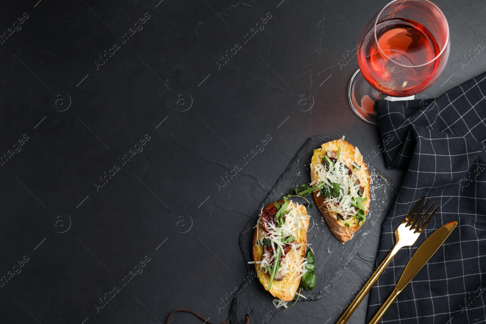 Photo of Delicious bruschettas with beef and cheese on black table, flat lay. Space for text