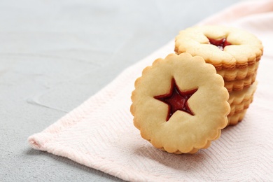 Photo of Traditional Christmas Linzer cookies with sweet jam on table