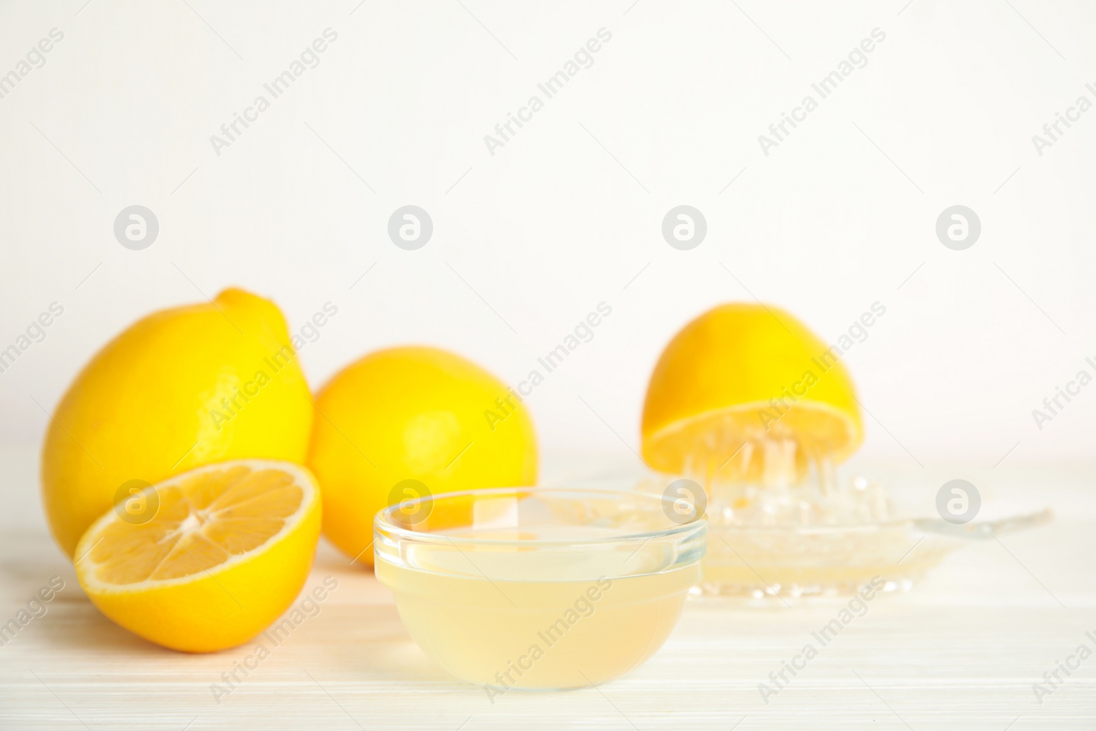 Photo of Freshly squeezed lemon juice on white table