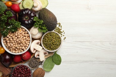 Different vegetables on white wooden table, flat lay and space for text. Vegan diet