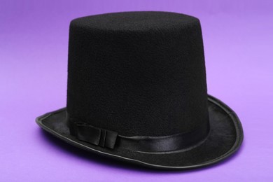 Photo of One magician top hat on violet background
