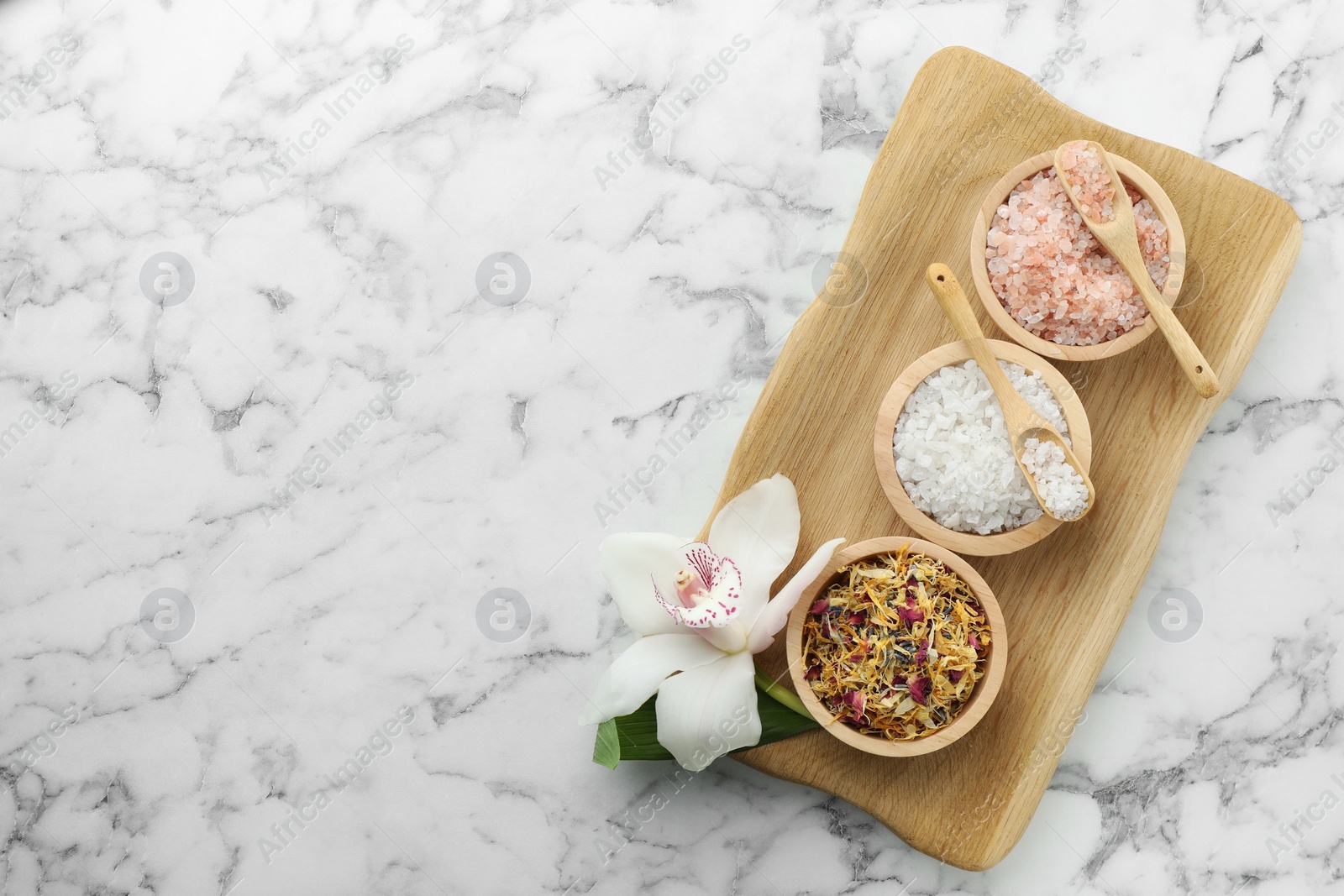 Photo of Flat lay composition with different spa products and orchid on white marble table. Space for text