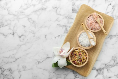 Photo of Flat lay composition with different spa products and orchid on white marble table. Space for text