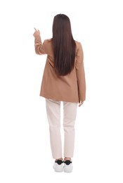 Businesswoman in suit pointing at something on white background, back view