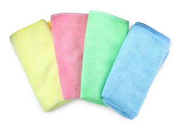 Colorful microfiber cloths on white background, top view