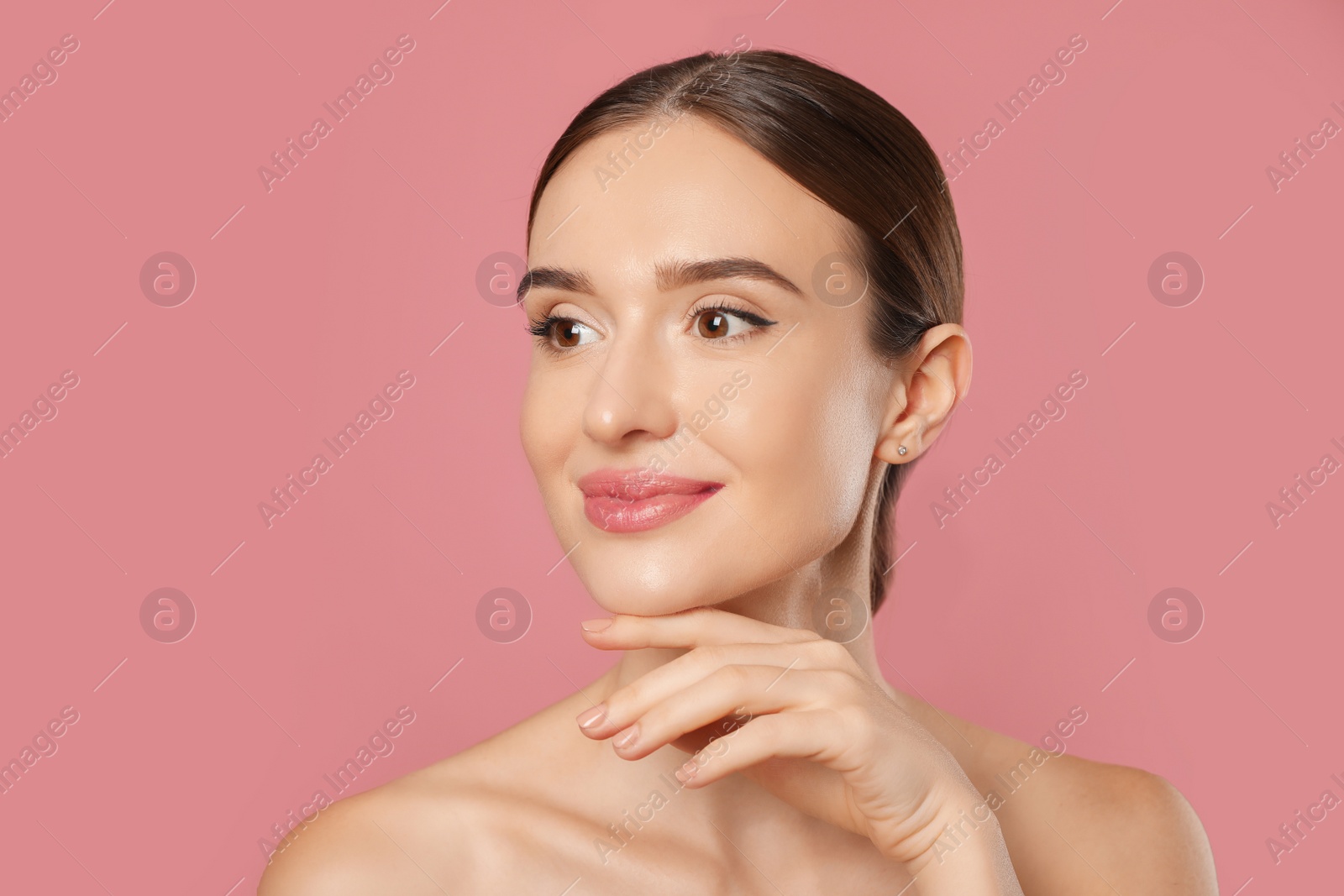 Photo of Beautiful woman with perfect smooth skin on pink background