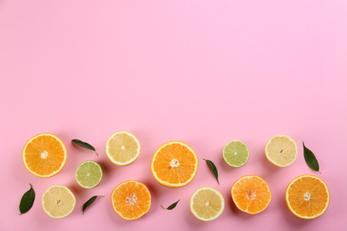 Photo of Flat lay composition with tangerines and different citrus fruits on pink background. Space for text