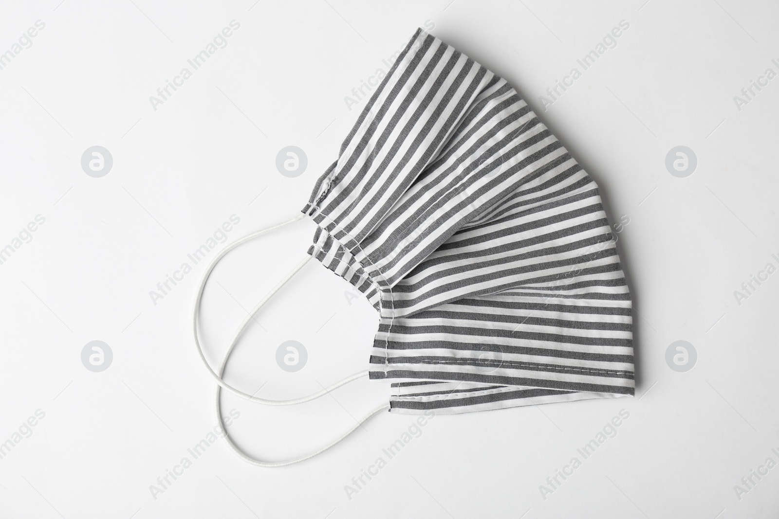 Photo of Homemade protective face mask on white background, top view