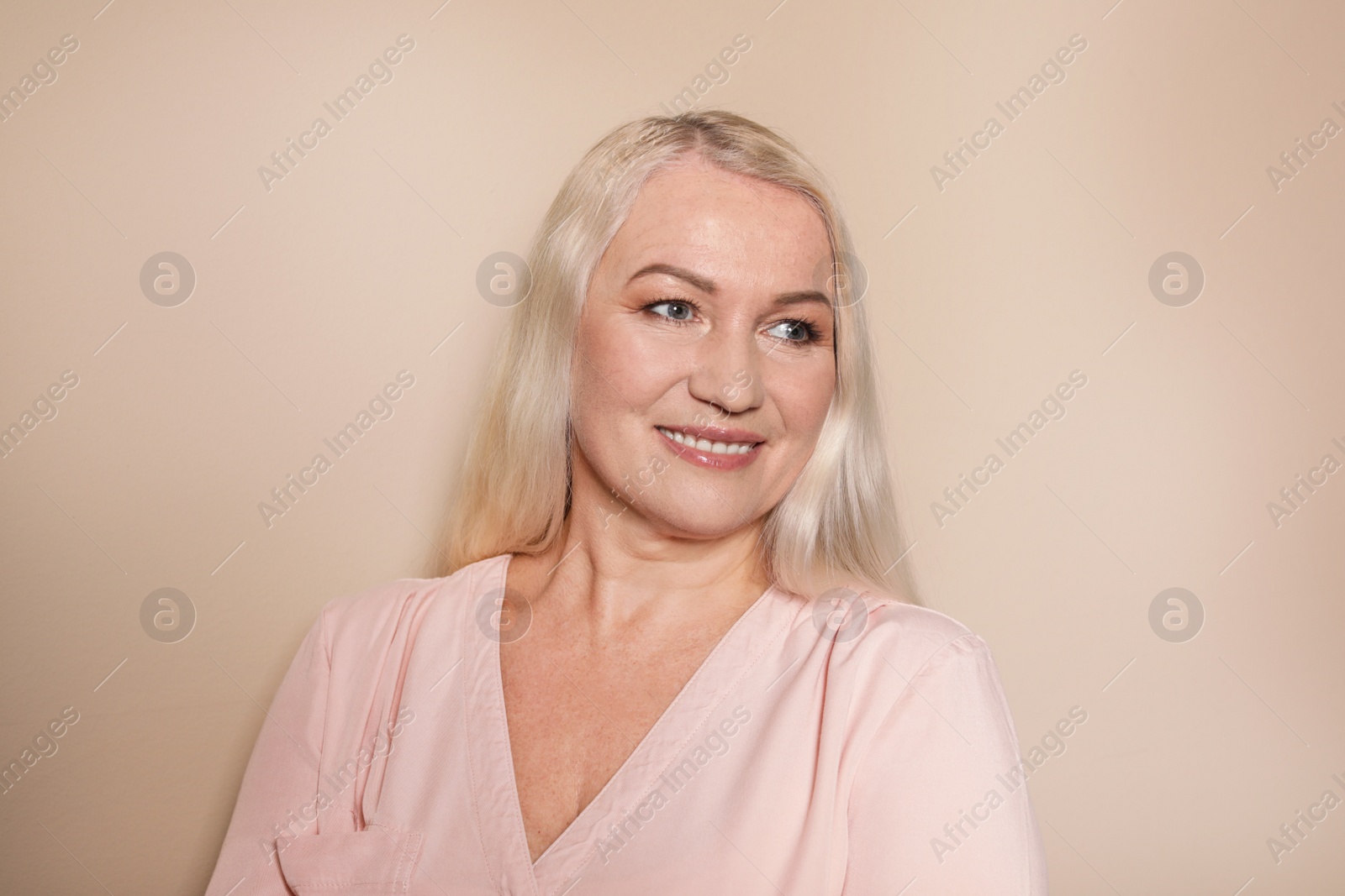 Photo of Portrait of mature woman on color background