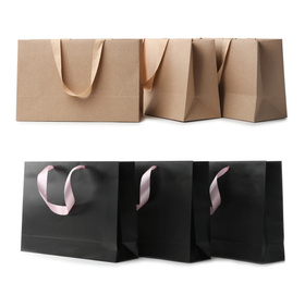 Set with different paper shopping bags on white background