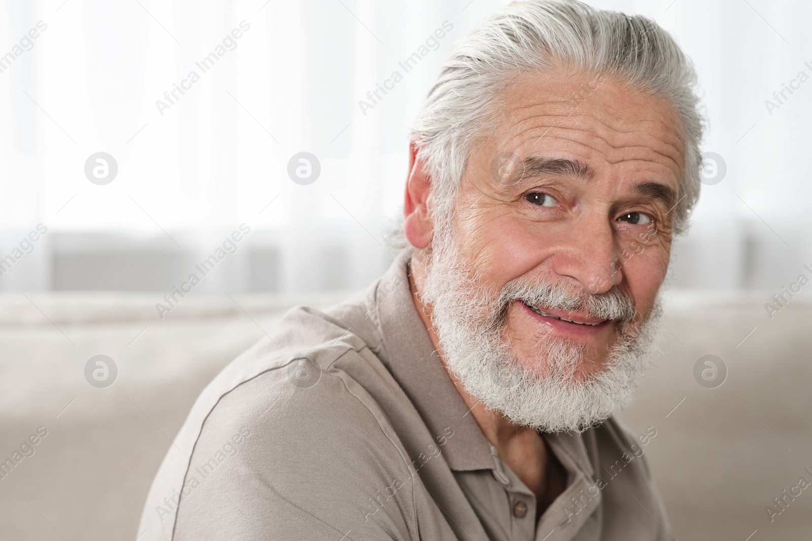 Photo of Portrait of handsome senior man at home