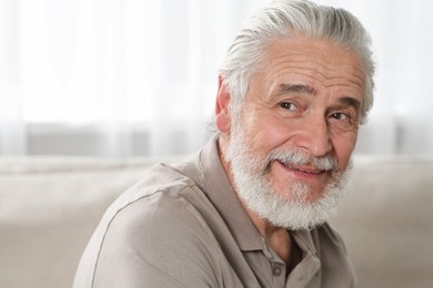 Portrait of handsome senior man at home