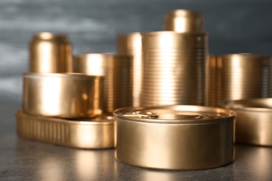 Photo of Many tin cans on table. Recycling garbage