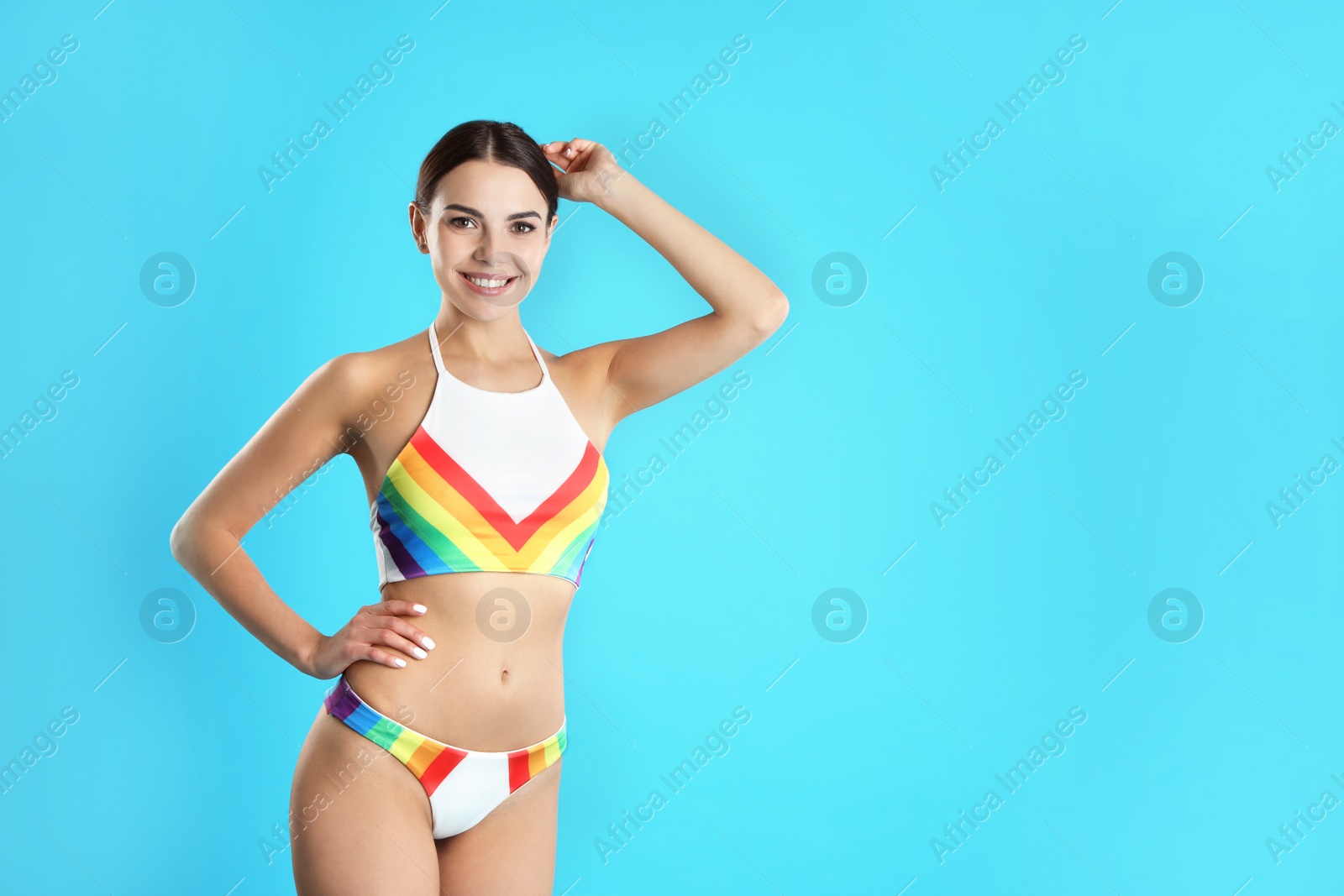 Photo of Portrait of attractive young woman with slim body in swimwear on color background. Space for text
