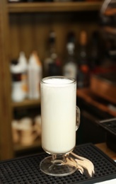 Photo of Glass cup of steamed milk for coffee drink on counter