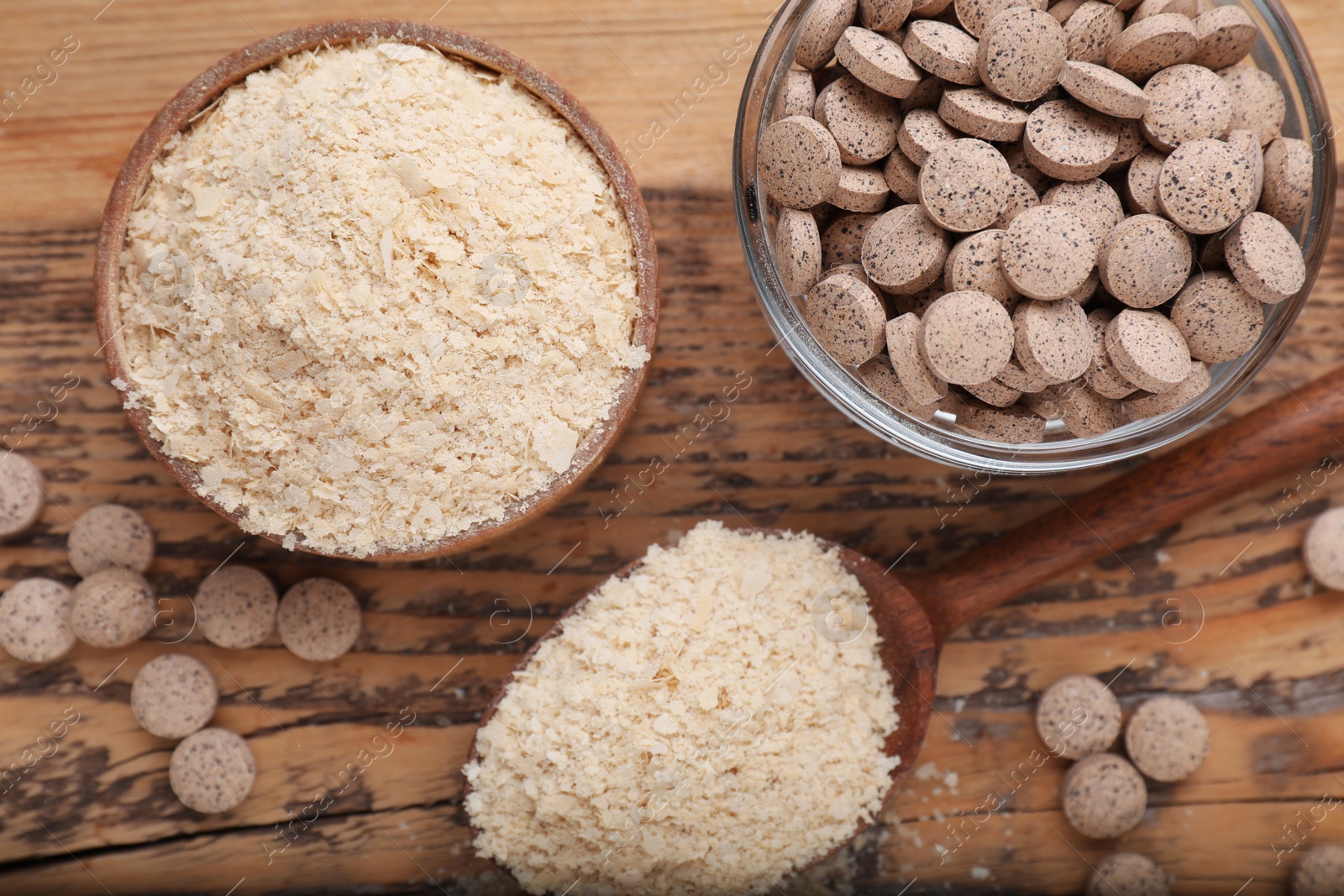 Photo of Different types of brewer`s yeast on wooden table, flat lay