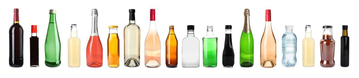 Image of Set of bottles with different liquids on white background. Banner design