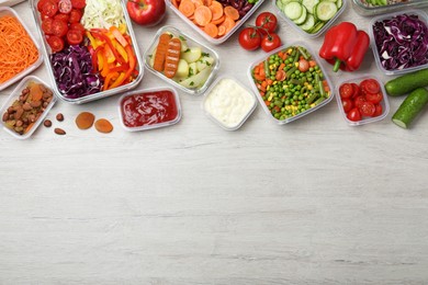 Photo of Set of containers with fresh food on white wooden table, flat lay. Space for text