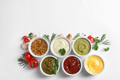 Composition with different sauces and ingredients on white background, flat lay. Space for text