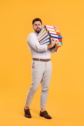 Photo of Stressful man with folders on orange background