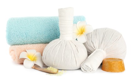Photo of Herbal massage bags and other spa products on white background