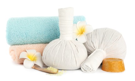 Herbal massage bags and other spa products on white background