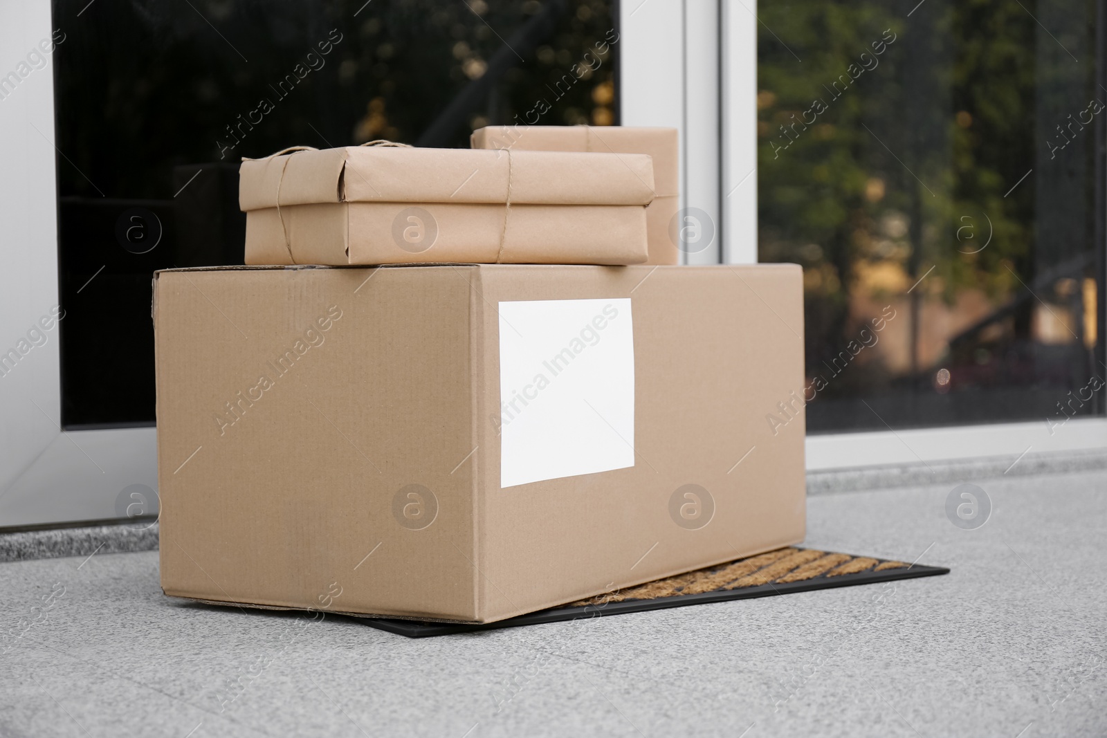 Photo of Delivered parcels on door mat near entrance