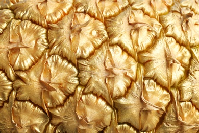 Photo of Golden pineapple as background, closeup. Creative concept