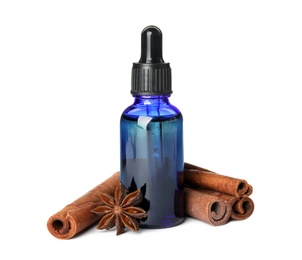 Photo of Bottle of essential oil and cinnamon sticks on white background