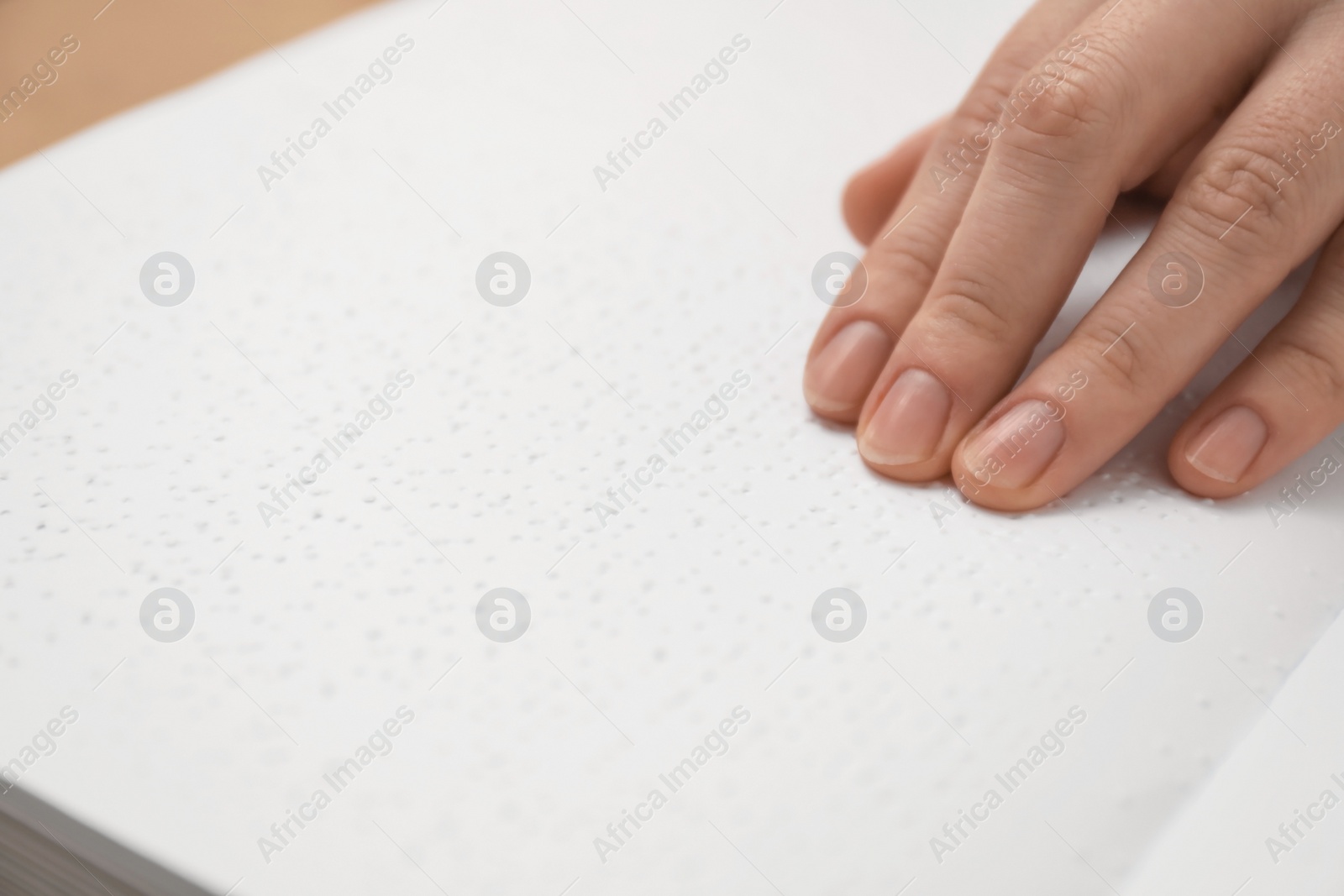 Photo of Blind woman reading book written in Braille, closeup