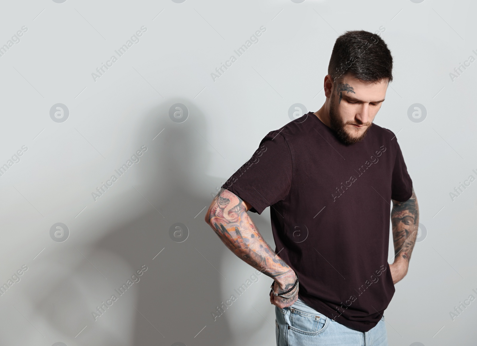 Photo of Handsome hipster man on light grey background. Space for text