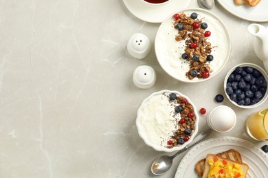 Photo of Delicious breakfast served on light marble table, flat lay. Space for text