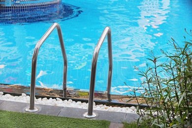 Modern swimming pool with stairs at resort