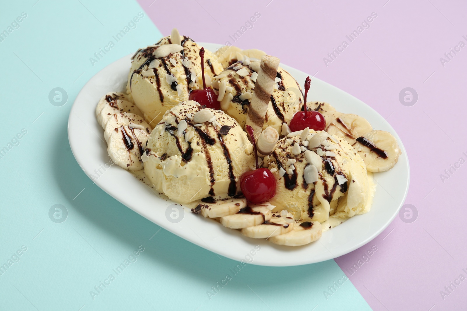 Photo of Delicious dessert with banana ice cream on color background