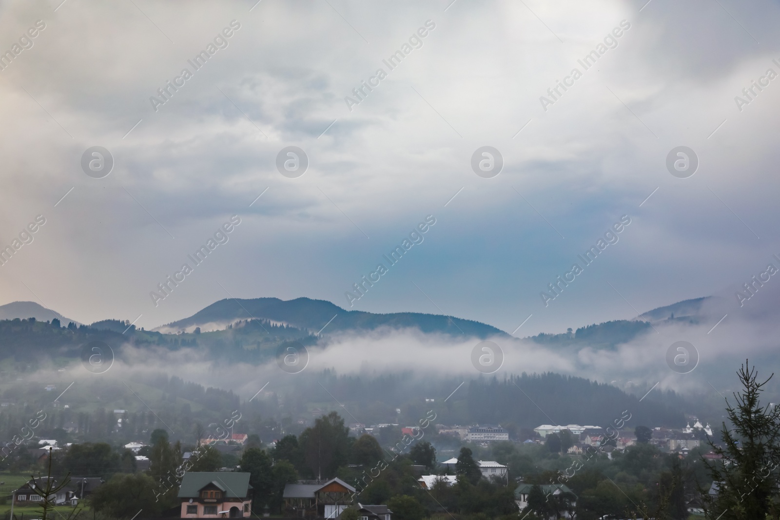 Photo of Picturesque view of mountain village with fog