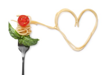 Photo of Heart made of tasty pasta, cut tomato and basil isolated on white