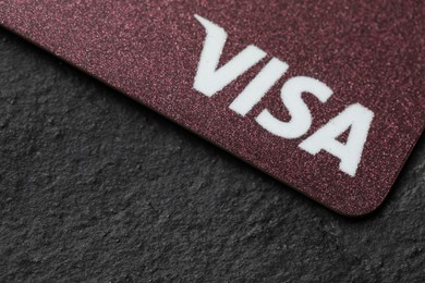 Photo of MYKOLAIV, UKRAINE - FEBRUARY 22, 2022: Visa credit card on black background, closeup. Space for text