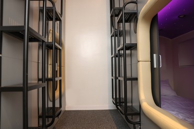 Capsule and ladders in modern pod hostel. Stylish interior
