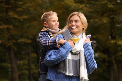 Photo of Happy mother with her son in autumn park