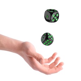 Man throwing black dice on white background, closeup