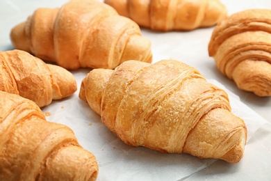 Photo of Tasty croissants on table, closeup