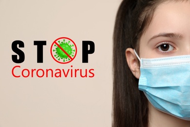 Stop Coronavirus text near little girl wearing medical mask on beige background, closeup. Protective measures during pandemic