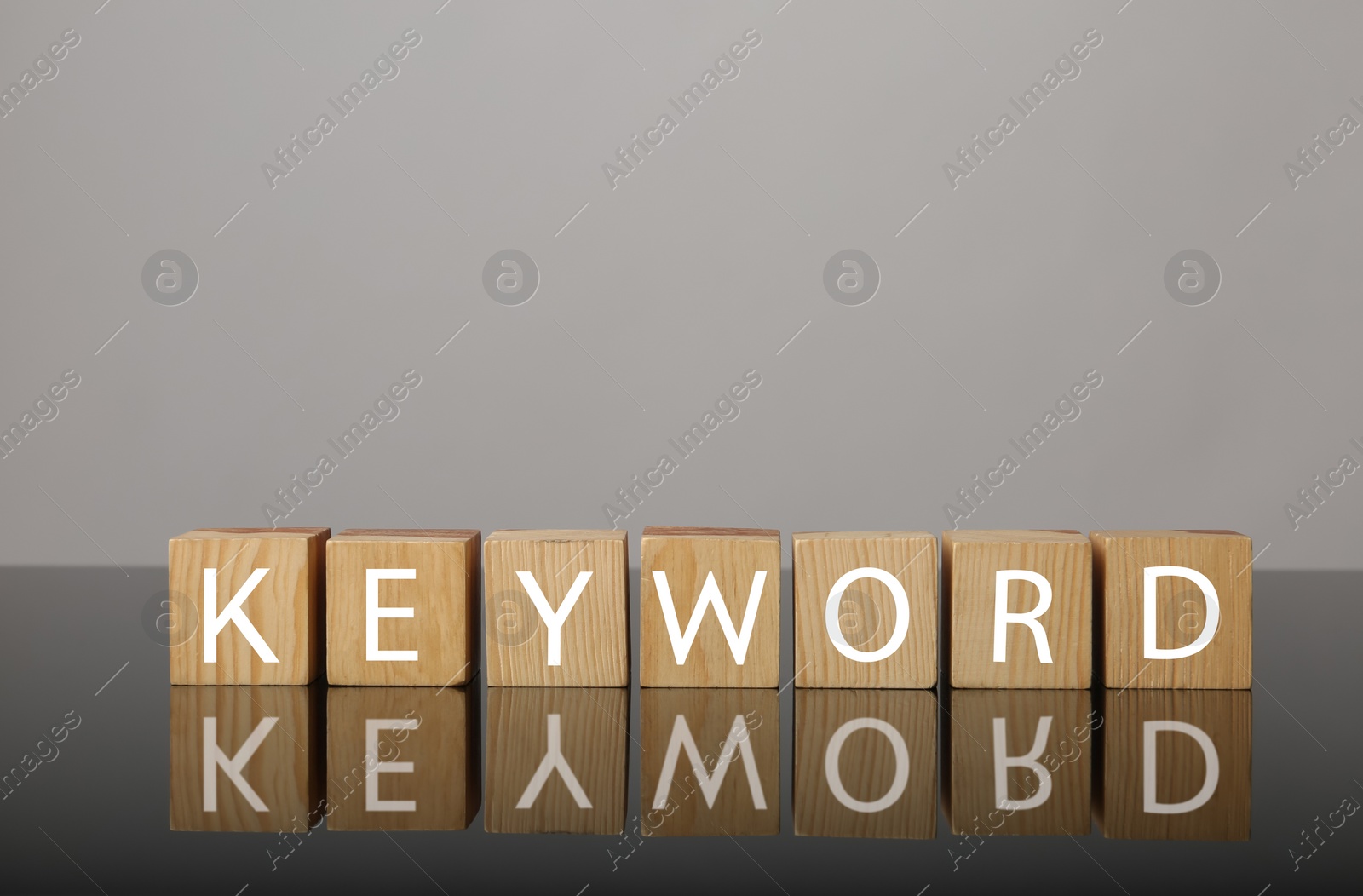 Photo of Wooden cubes with word KEYWORD on grey background