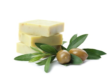 Handmade soap bars and leaves with olives on white background
