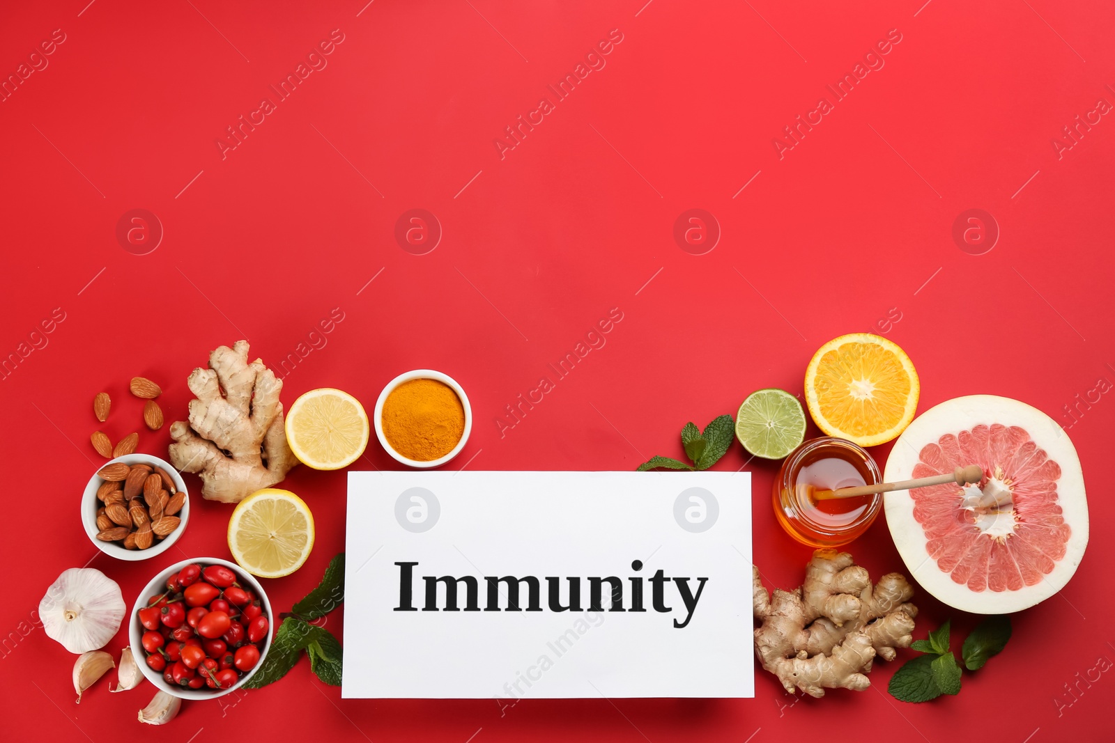 Photo of Set of natural products and card with word Immunity on red background, flat lay. Space for text