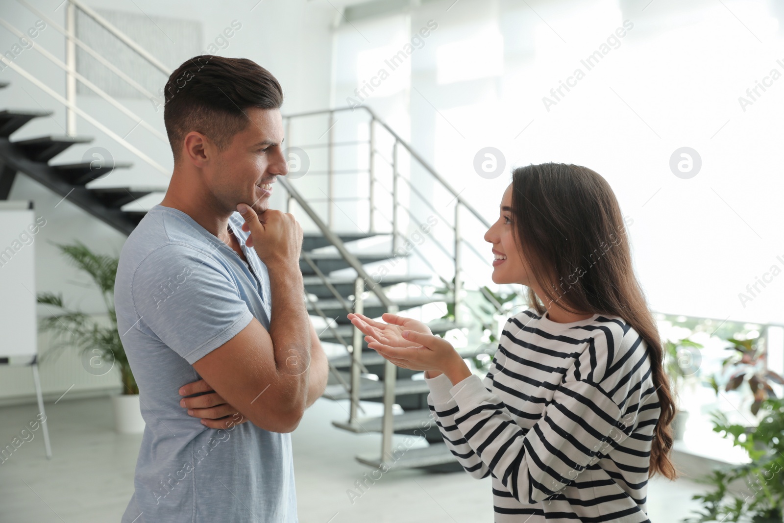 Photo of Man and woman having conversation in hall