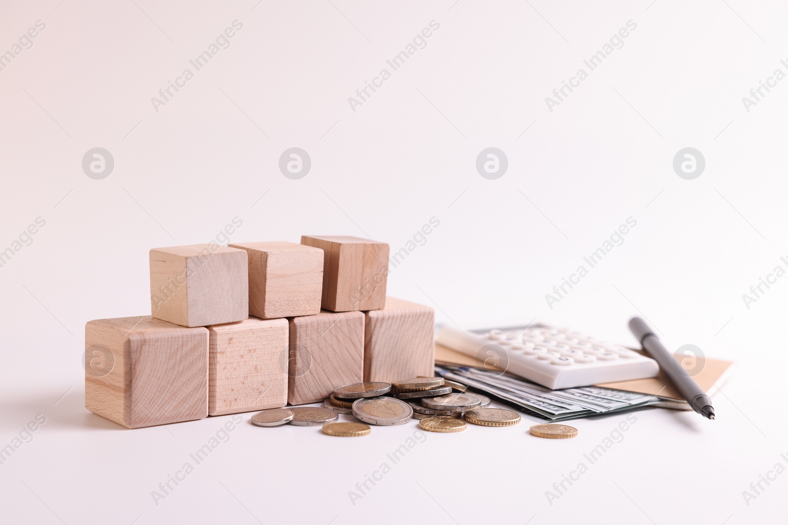 Photo of Word Tax, number 2024 made of wooden cubes, calculator, coins and banknotes on white background