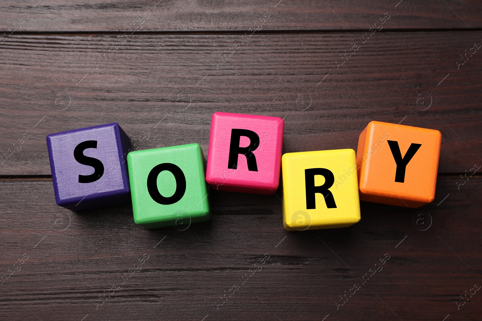 Image of Apology. Word Sorry made of colorful cubes on wooden table, top view